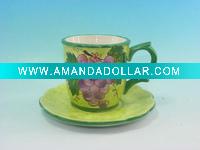 green ceramic coffee cup with saucer