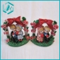 Wholesale resin gift 11*9 cm bride and groom arming together around under a rose tree with a big red butterfly tie